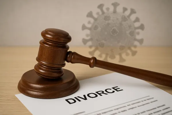 A gavel rests on top of a legal document, symbolizing the intersection of law and personal matters in divorce proceedings. The background features a subtle overlay of the COVID-19 virus illustration, representing the pandemic's impact on legal processes.