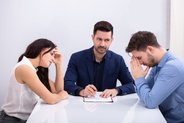 Mediator meeting with two people at a table.