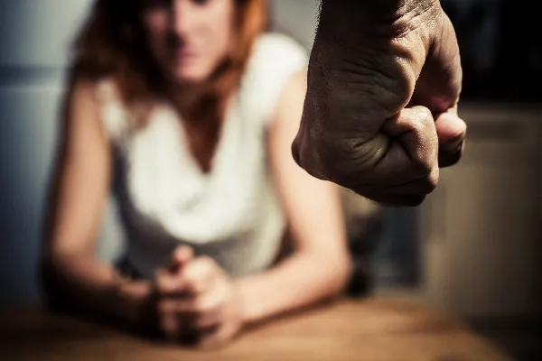 Photo of a distressed woman with bruises on her arms, representing the physical aspect of domestic abuse discussed in the blog post about Oregon's definition of domestic abuse.. What qualifies as domestic abuse in Oregon?